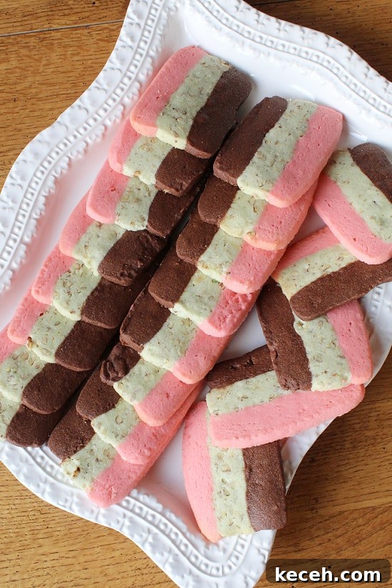 Italian Spumoni Cookies are homemade goodness, festive, and they melt in your mouth. Tri-flavored and colored cookies with chocolate, nuts, and rum flavors.