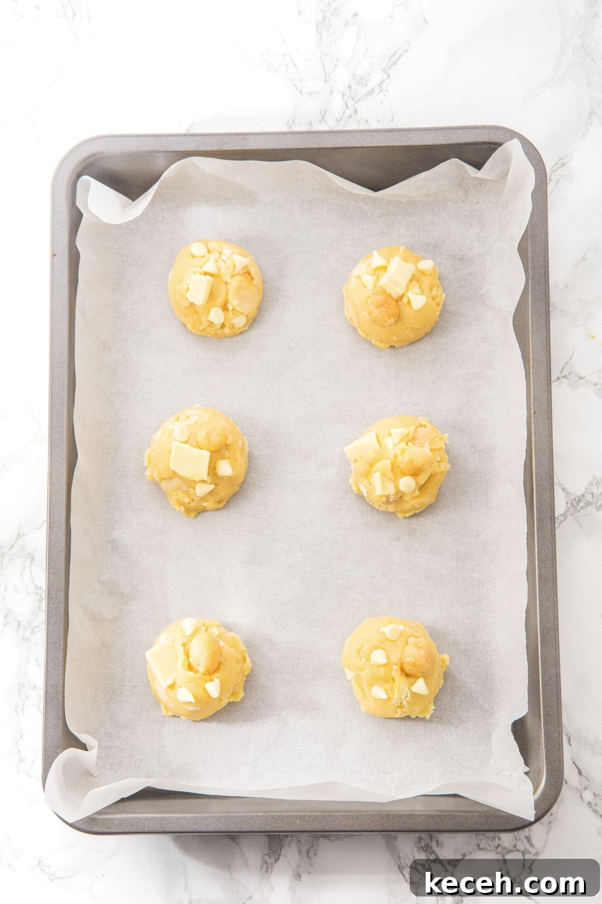 Gluten Dairy-Free Macadamia Cookies Cookie dough balls on parchment-lined baking sheet