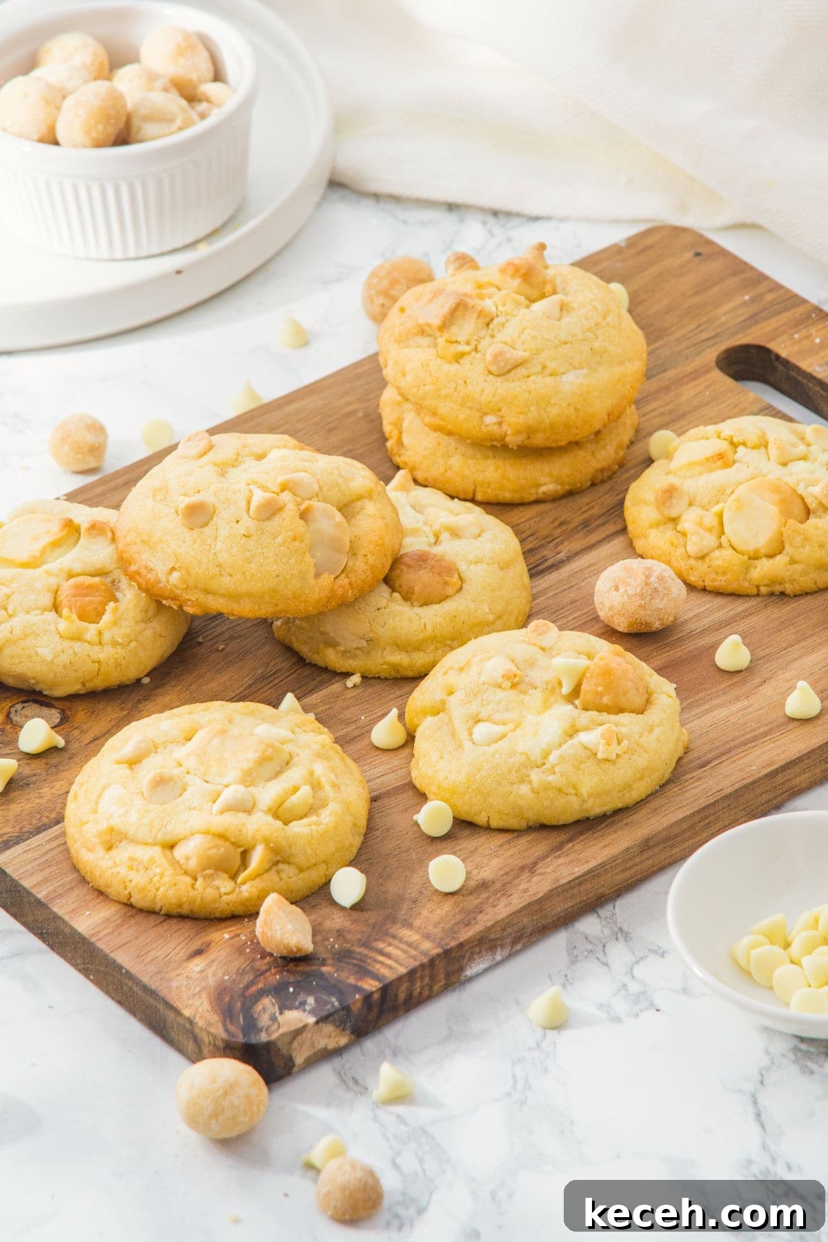 White Chocolate Macadamia Nut Cookies (Gluten-Free, Dairy-Free) White chocolate macadamia nut cookies on wooden board.