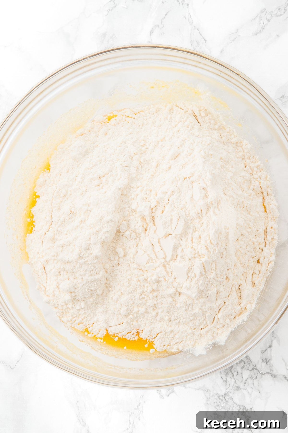 Macadamia White Chocolate Cookies Flour on top of yellow mixture