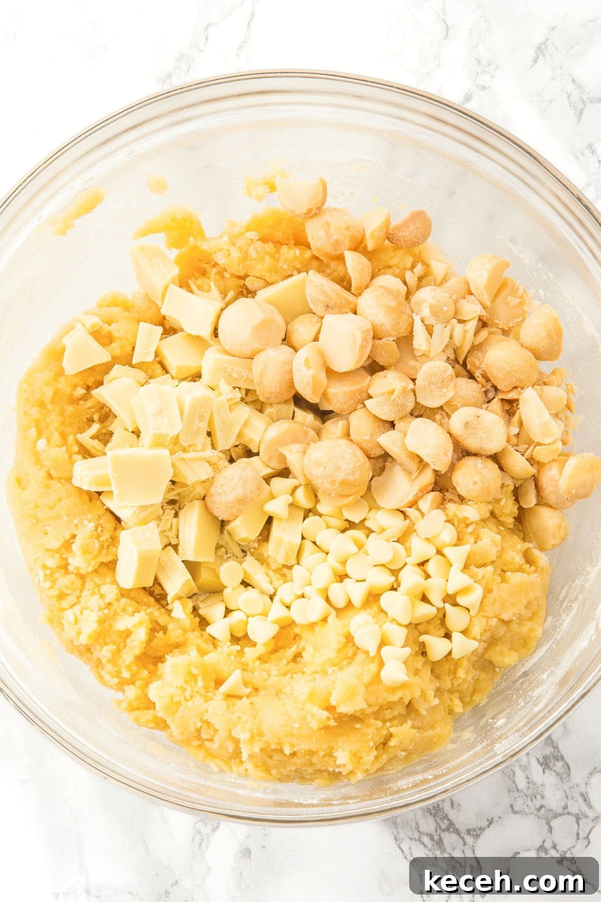 Gluten-Free, Dairy-Free White Chocolate Macadamia Cookies 3 White chocolate and macadamia nuts on top of cookie dough