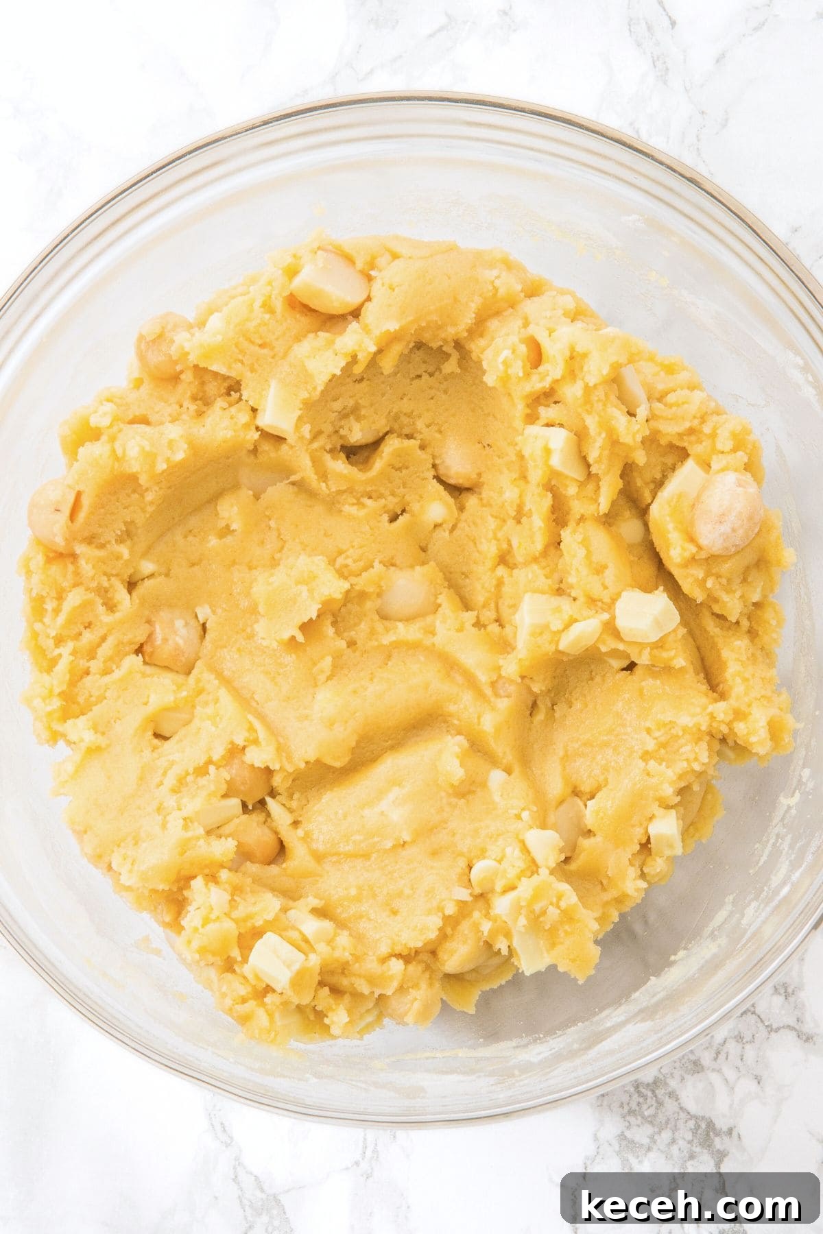 Gluten-Free White Chocolate Macadamia Cookies White choc macadamia cookie dough in glass bowl