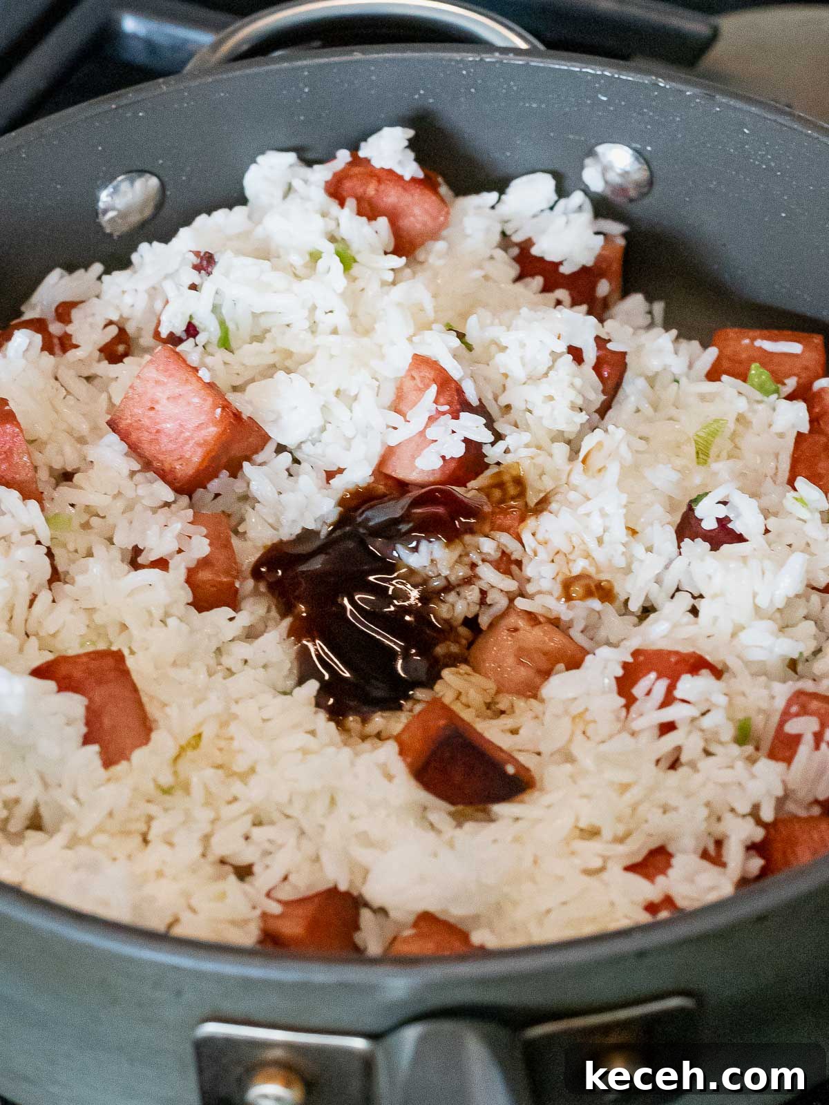 Simple Spam Fried Rice Recipe for Quick Weeknight Meals 10 spam and rice frying in a nonstick pan