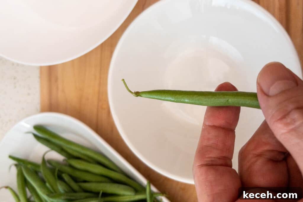 Showing bean end to be snapped off before cooking