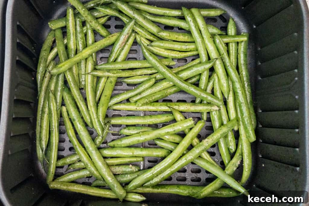 green beans in basket seasoned and sprayed with oil