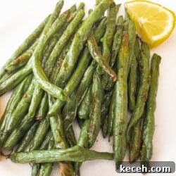 Green Beans on white plate with lemon wedge