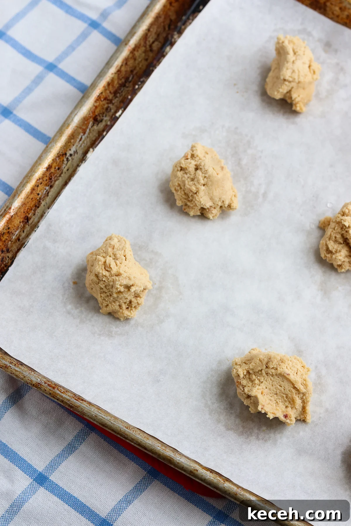Crispy Peanut Butter Cookies Recipe: Crunchy, Golden Treats 6 scoops of peanut butter cookie dough on parchment lined baking sheet