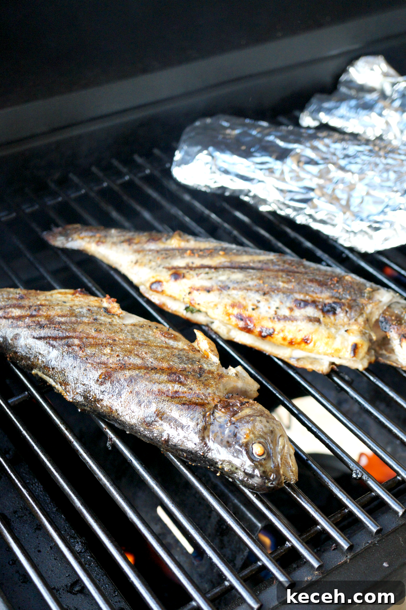 Whole Grilled Trout Recipe: Crispy Skin and Lemon Herb Flavor 5 grilled trout on the grill