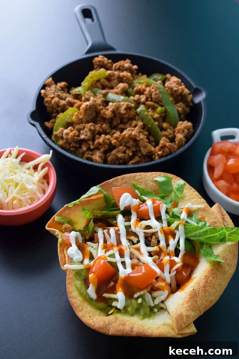 Turkey Enchirito Bowls: Flavorful Tex-Mex Dinner Recipe 3 Turkey Enchurrito Bowl with cast iron of cooked turkey behind it