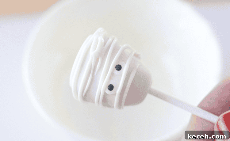 halloween mummy pop dipped in white chocolate and drizzled in white chocoalte