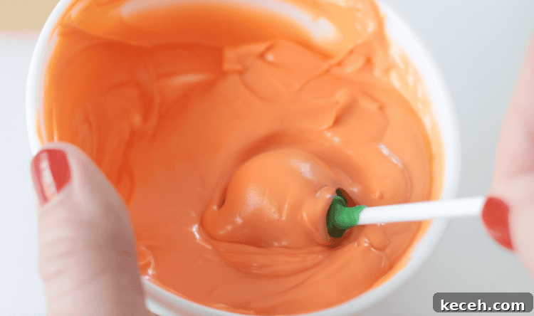 brownie pop dipped in orange melting candies