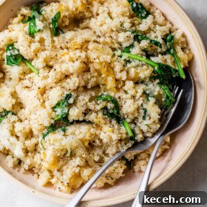 Caramelized Onion Quinoa Bowl with Herbed Lemon Dressing 7 quinoa, onions and spinach in a pink bowl
