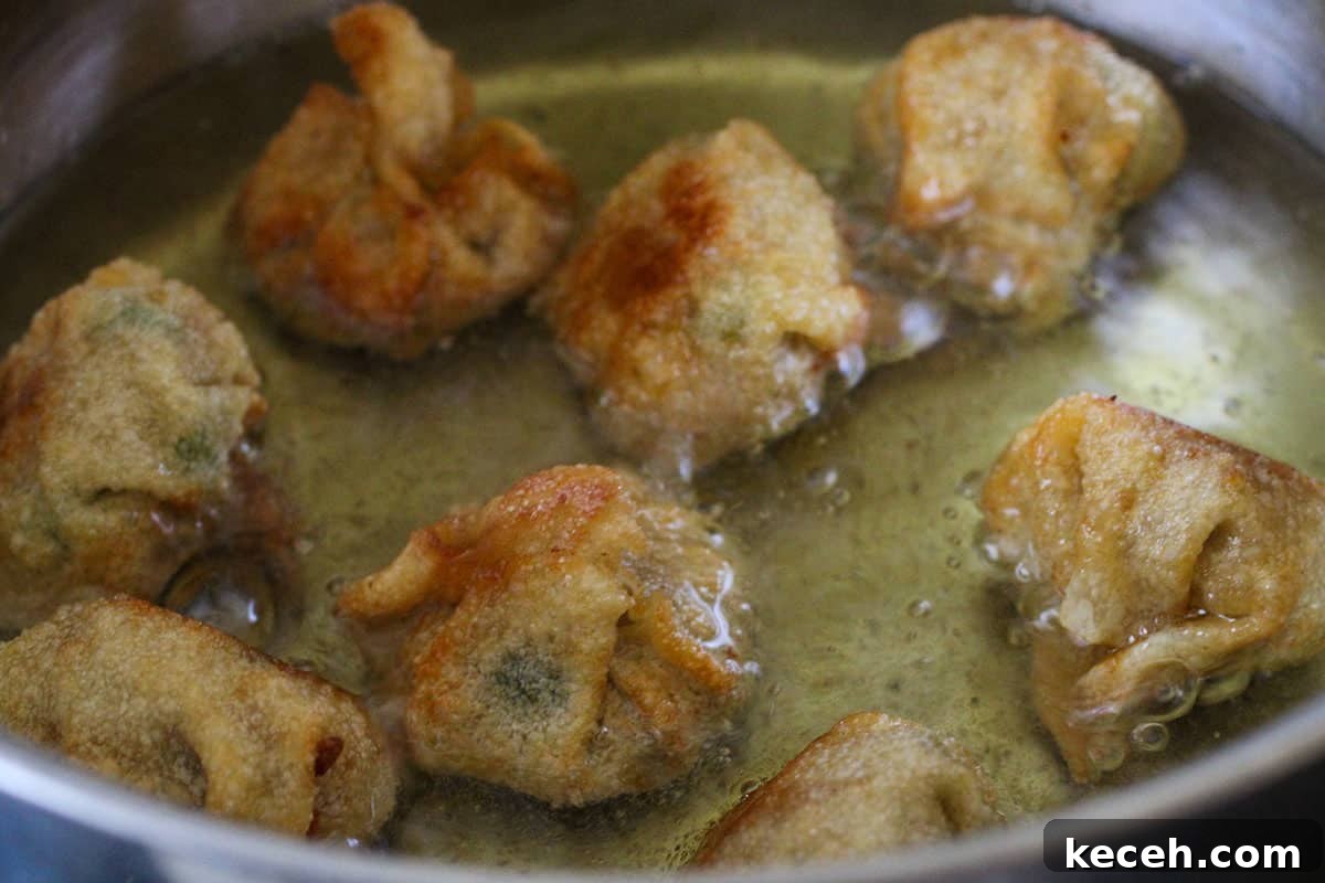 frying longganisa wontons in a pan.