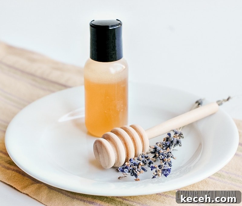 15 Smart Uses for Castile Soap: Home, Cleaning & Personal Care 11 homemade honey face wash in a small bottle on a white plate with lavender flowers and honey scoop