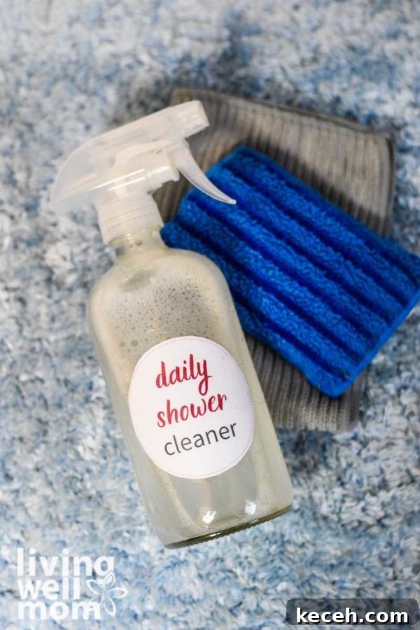 15 Smart Uses for Castile Soap: Home, Cleaning & Personal Care 9 clear spray bottle with daily shower cleaner, blue sponge, and grey towel