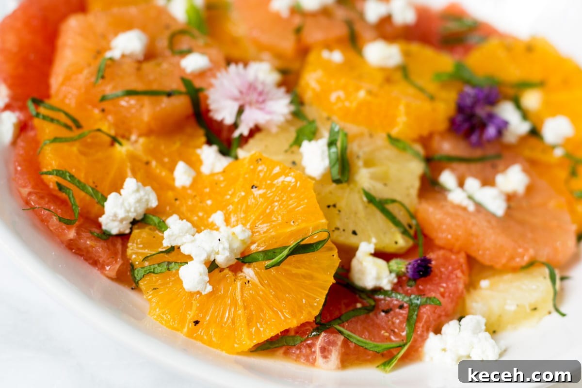 Citrus Salad with Honey-Balsamic Vinaigrette Recipe 4 closeup of citrus salad with goat cheese on a white platter