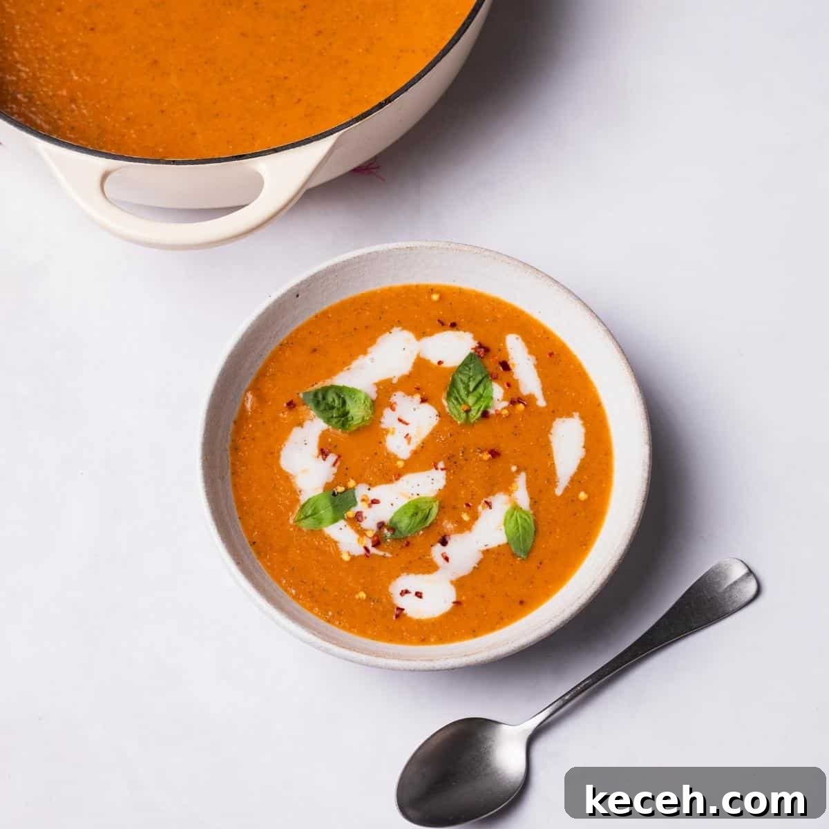 Creamy Roasted Tomato Soup Recipe with Garlic and Basil 2 Roasted Tomato Soup with vegan cream and fresh basil on top.