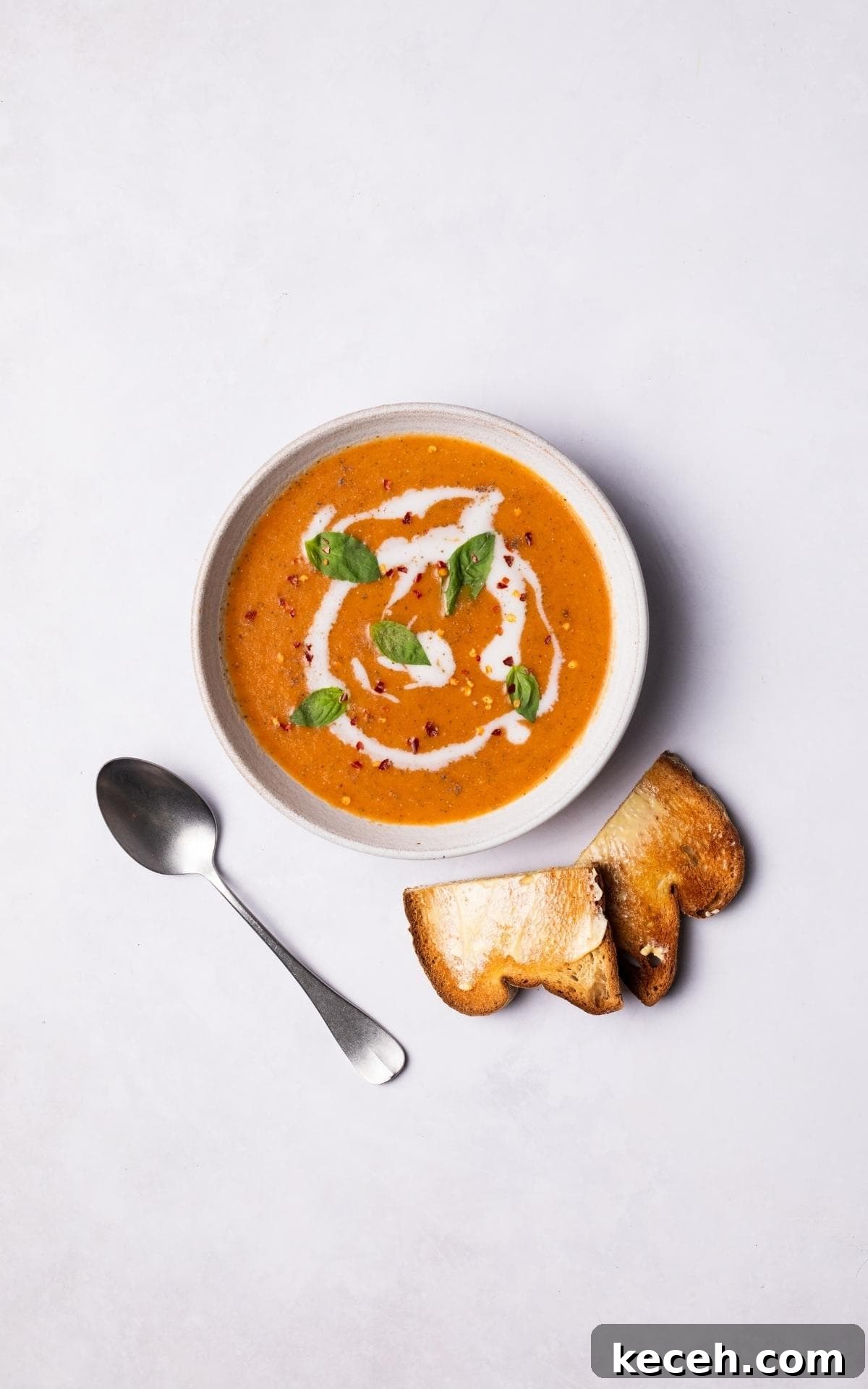 Creamy Roasted Tomato Soup Recipe with Garlic and Basil 8 Roasted Tomato Soup served with a slice of toast.