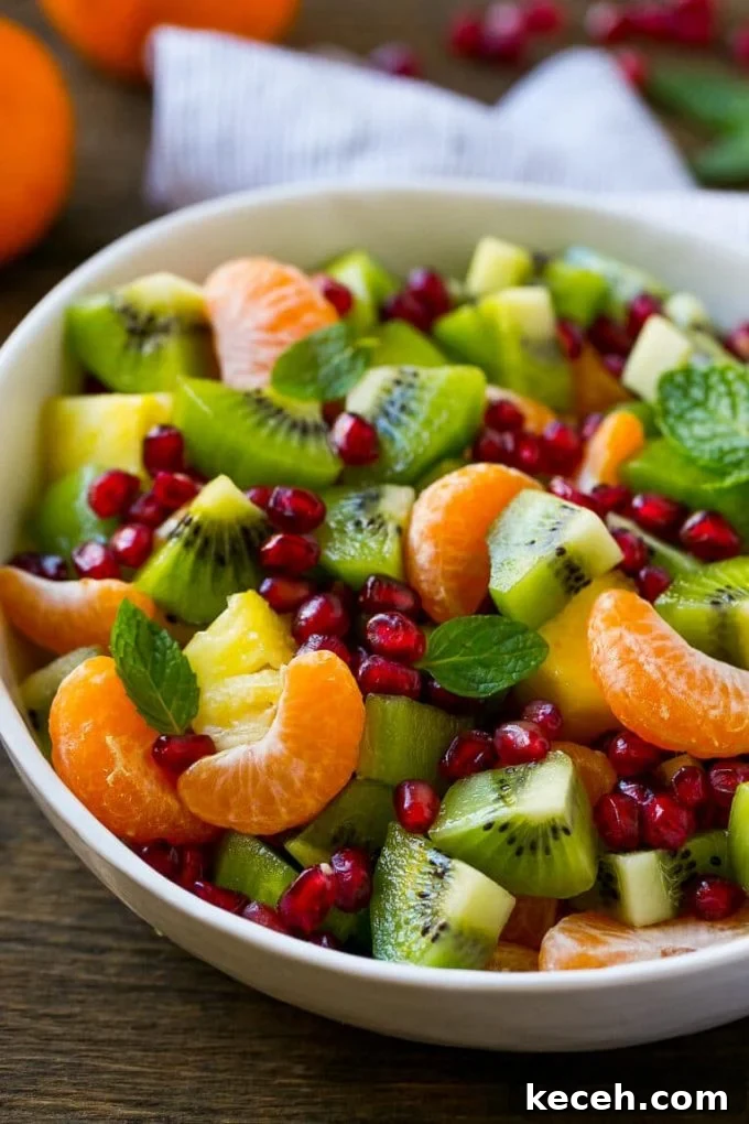 This winter fruit salad is made with oranges, kiwi, pineapple and pomegranates.