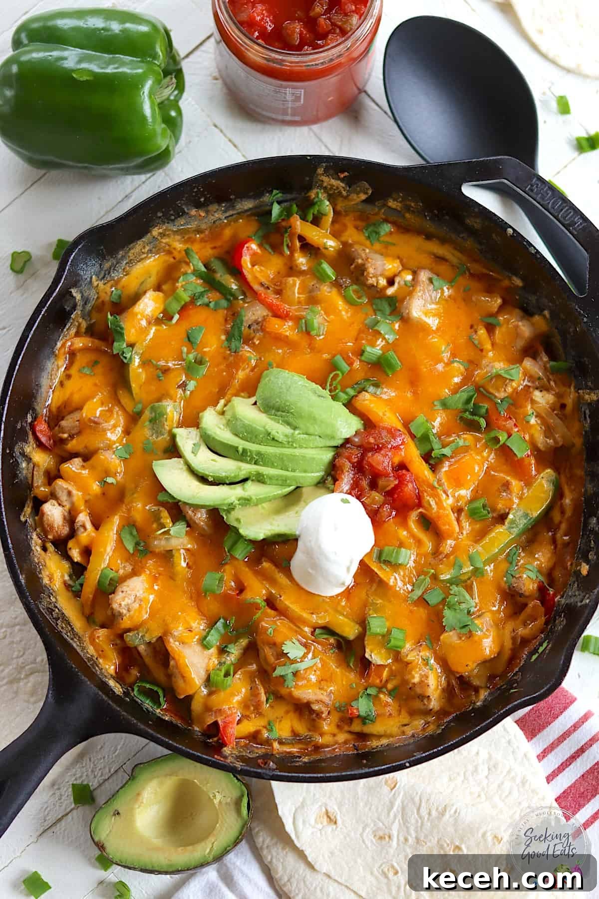 Chicken fajita casserole baked in a large cast iron skillet.