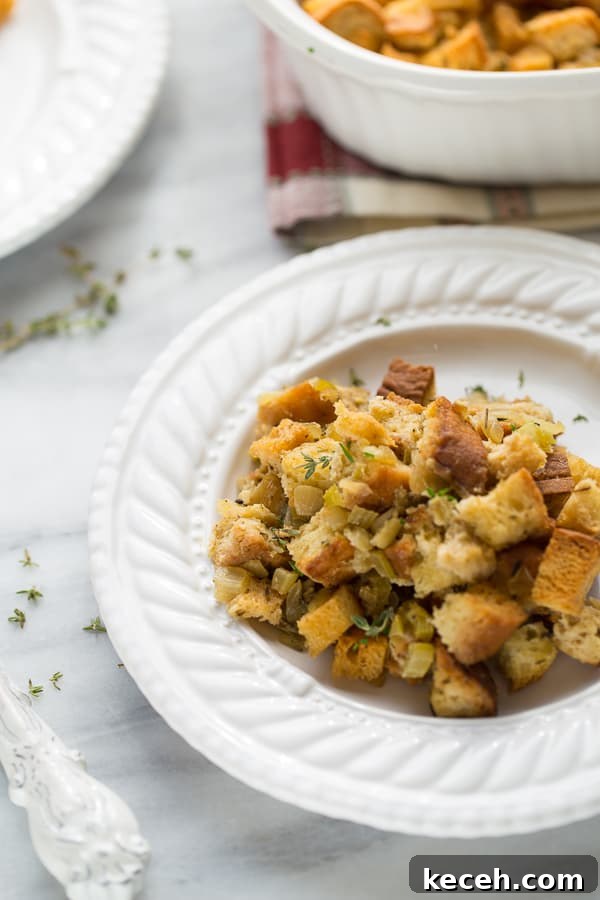 stuffing on white plate topped with thyme 