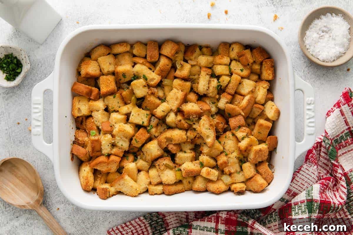 Baked stuffing in a casserole dish with red and green dish cloth