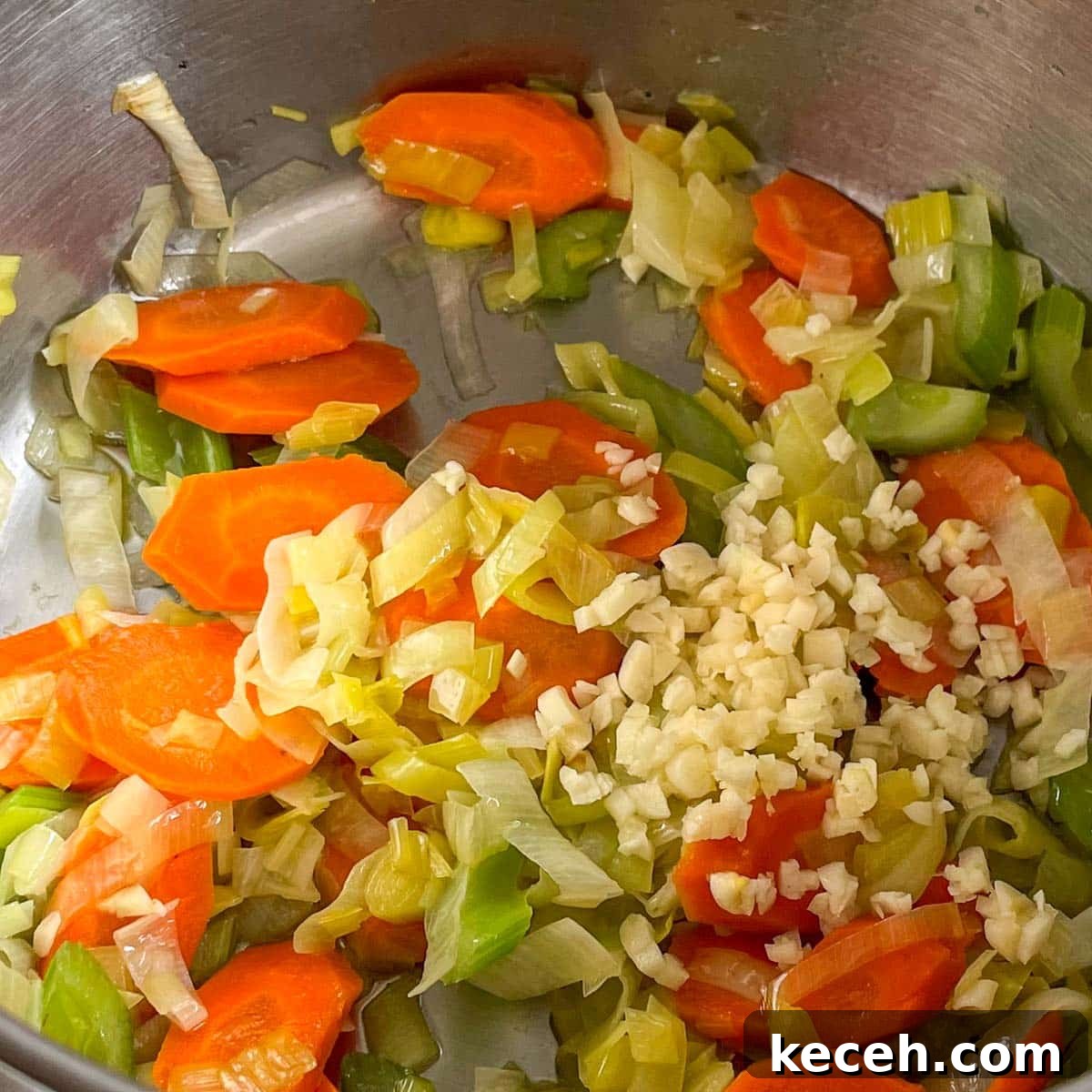 Authentic Greek Chickpea Soup (Revithosoupa) Recipe 8 Minced garlic is added to sauteed carrot, celery, and leek in a stainless steel pot.