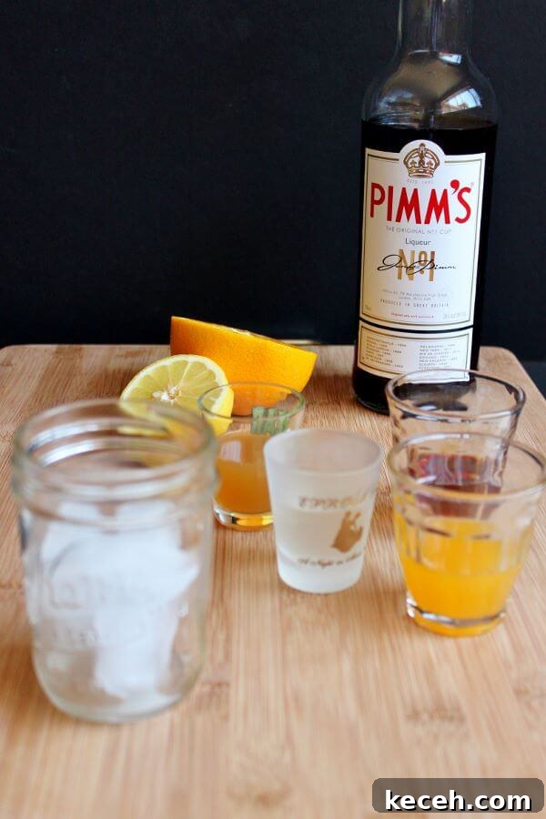 Pimm’s Sundowner Cocktail Recipe: Refreshing Evening Drink 4 Making a Pimm's Sundowner, starting with ice in the glass.