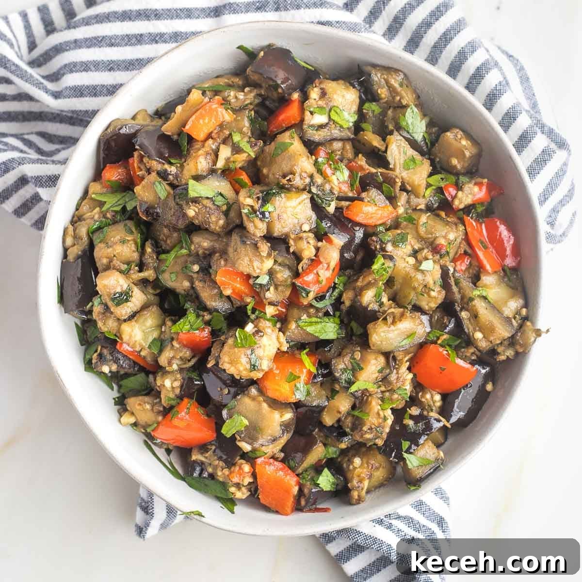Rosh Hashanah 2026: Festive Recipes and Complete Menu Planner 16 Bowl of cubed and sauteed eggplant with garlic, red peppers and parsley.