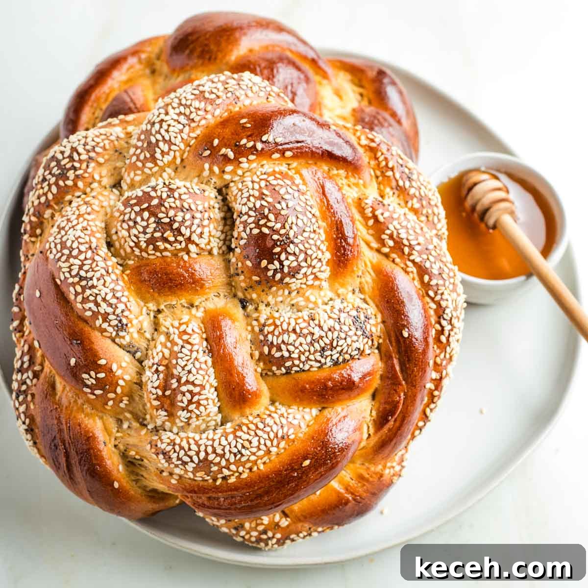 Rosh Hashanah 2026: Festive Recipes and Complete Menu Planner 3 Round, braided challah bread with honey for dipping.