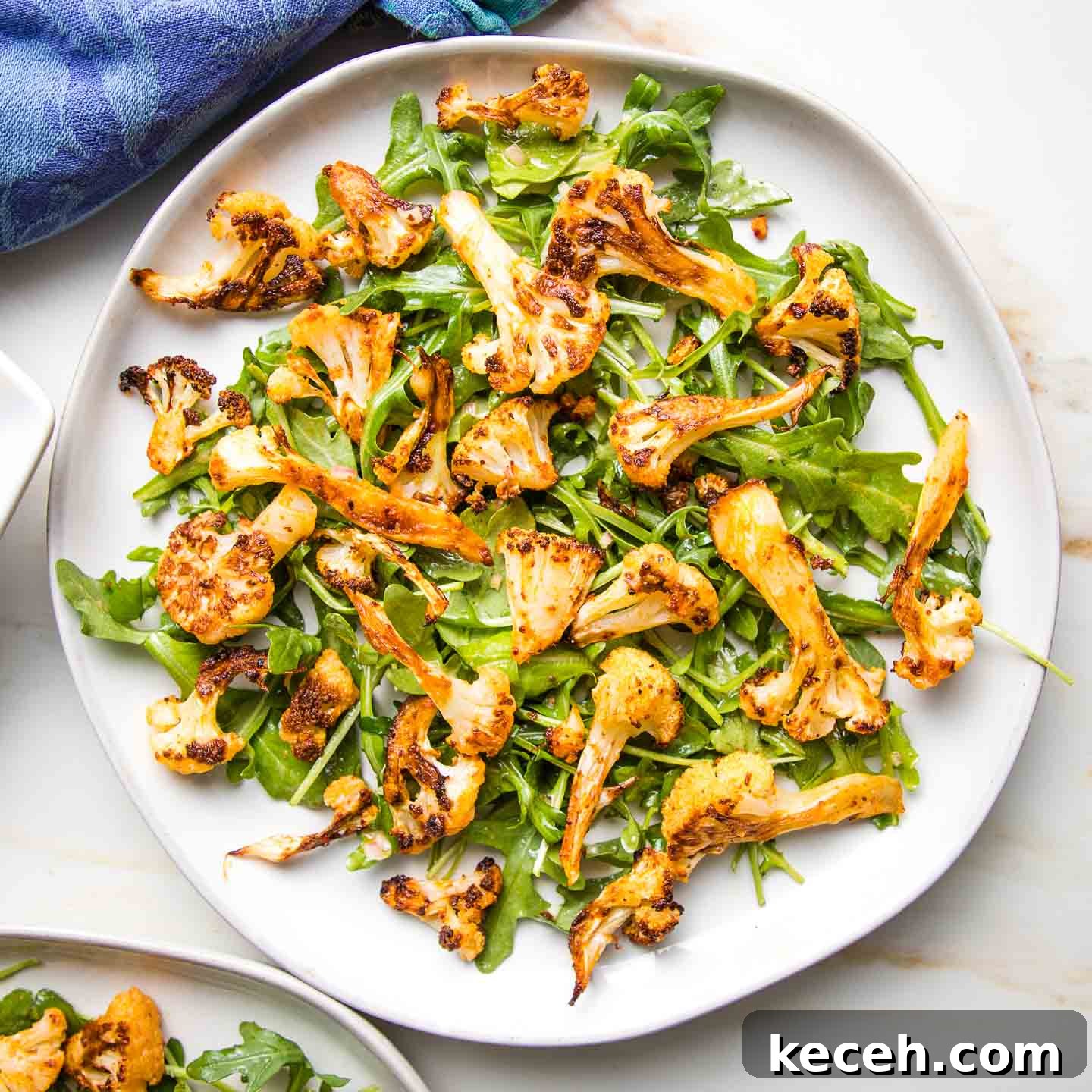 Rosh Hashanah 2026: Festive Recipes and Complete Menu Planner 21 Arugula topped with roasted cauliflower.