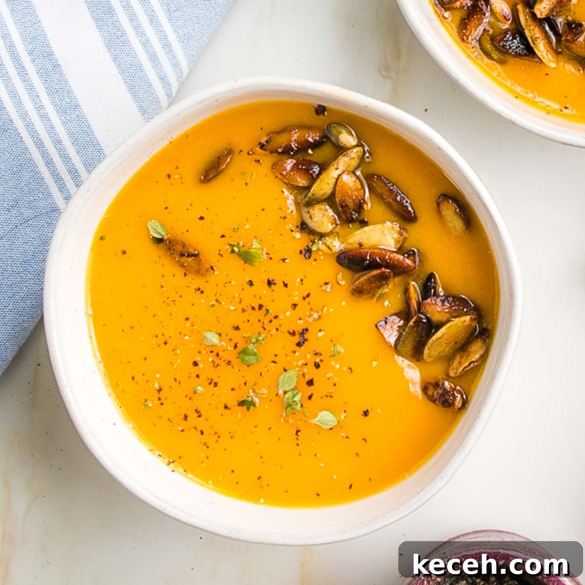 Rosh Hashanah 2026: Festive Recipes and Complete Menu Planner 24 Bright orange creamy soup with pepitas.