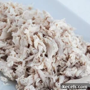 How to Poach Chicken Breast for Perfect Shredded Meat 4 Shredded chicken on a white platter.