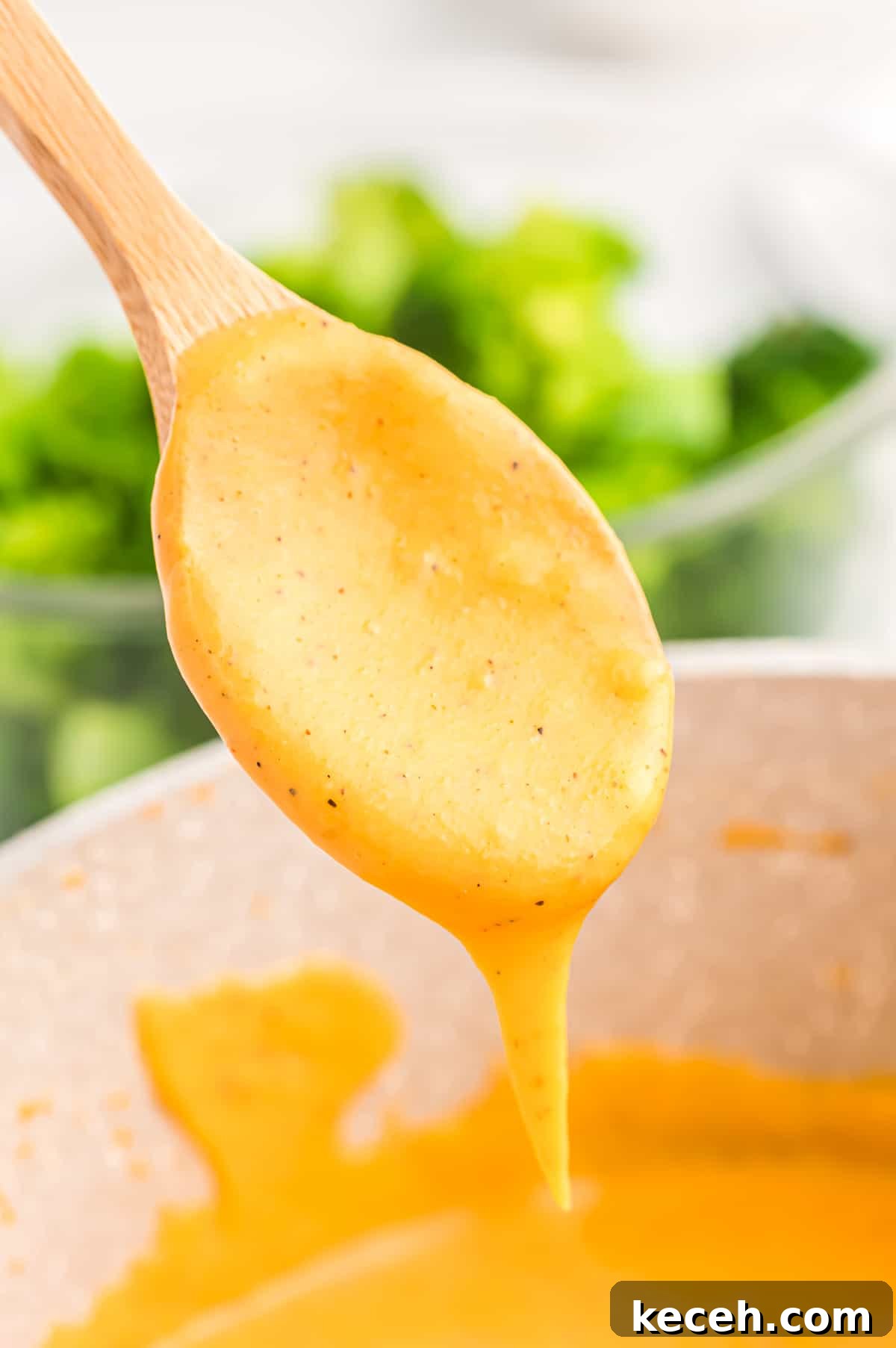 Creamy Cheese Sauce for Broccoli: Quick Recipe & Tips 3 spoon dripping with cheese sauce