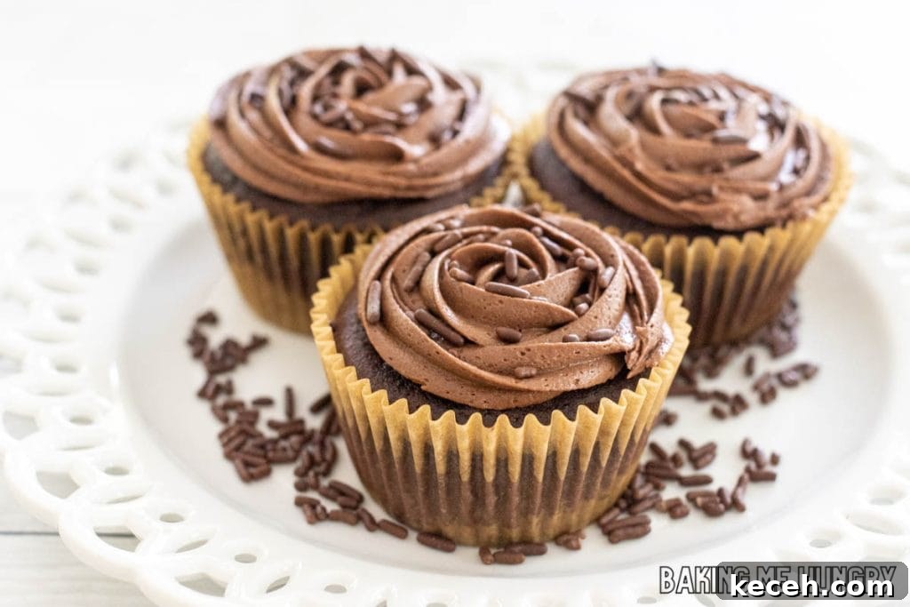 Rich Chocolate Frosting Recipe for Small Batches 8 small batch chocolate frosting shown on 3 chocolate cupcakes on a white plate
