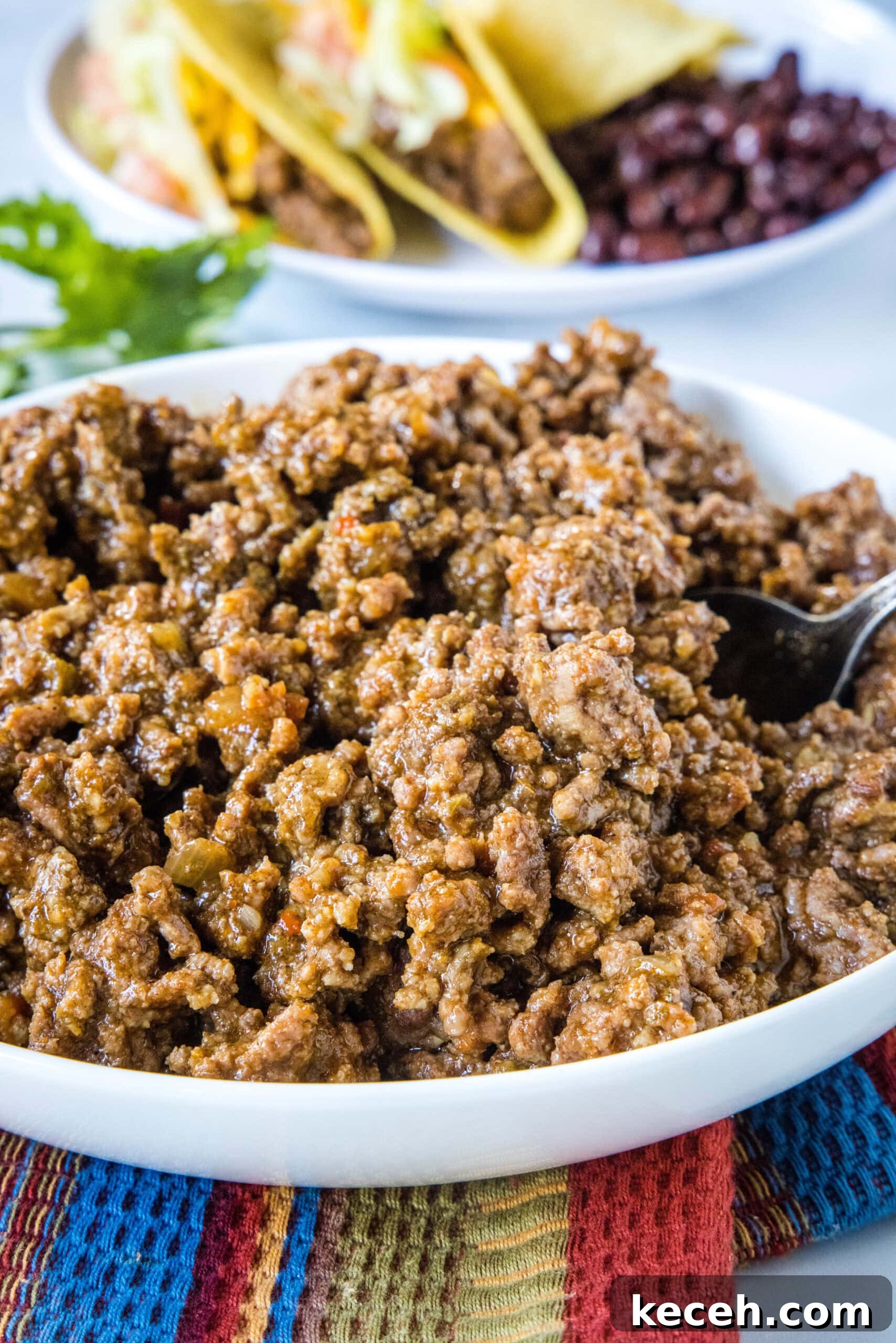 Slow cooker taco meat in a large white bowl.