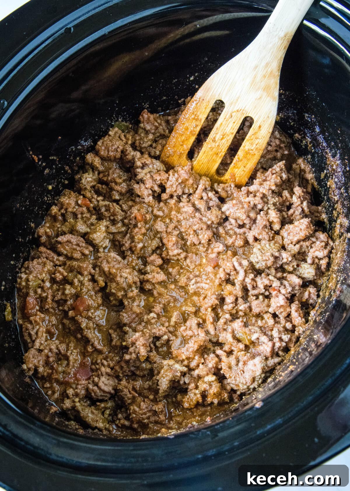 Browned ground beef taco meat inside the slow cooker.