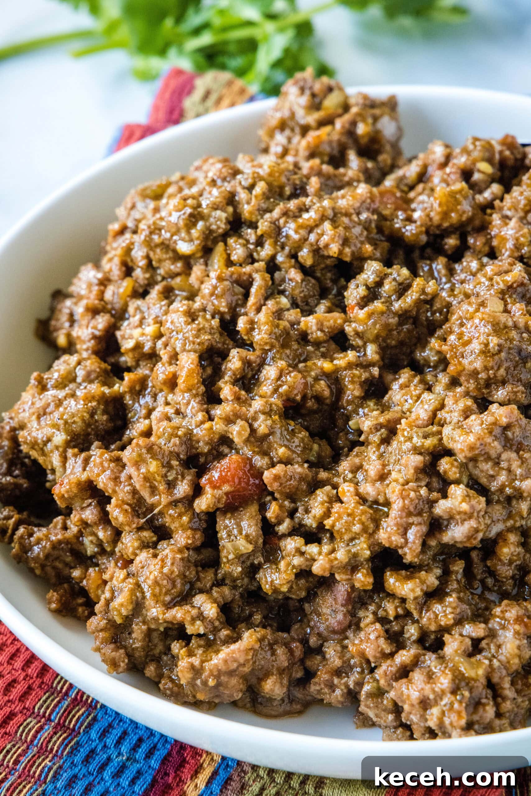 Slow cooker taco meat in a large white bowl.