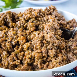 Slow cooker taco meat in a large white bowl.