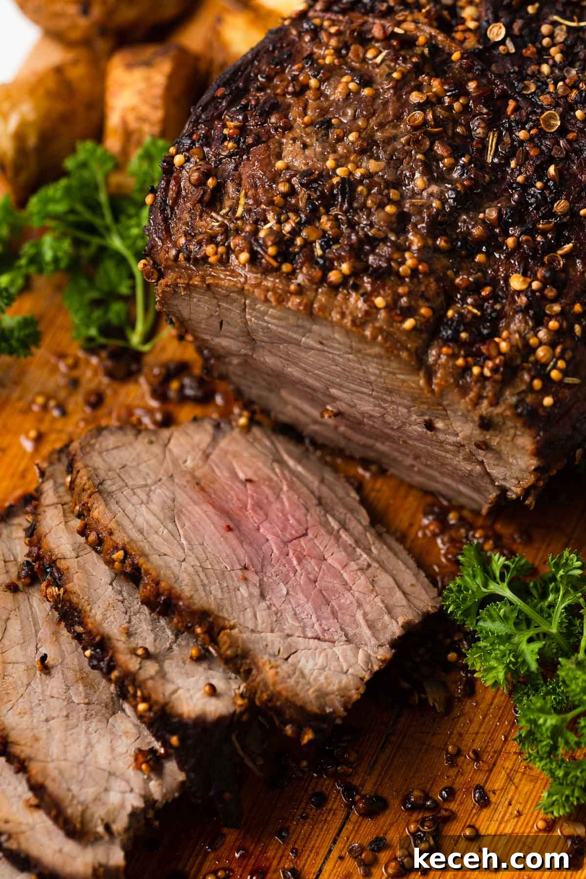 sliced air fried roast beef on a board.