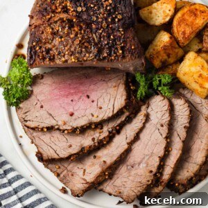 air fryer roast beef sliced and on a plate with potatoes.