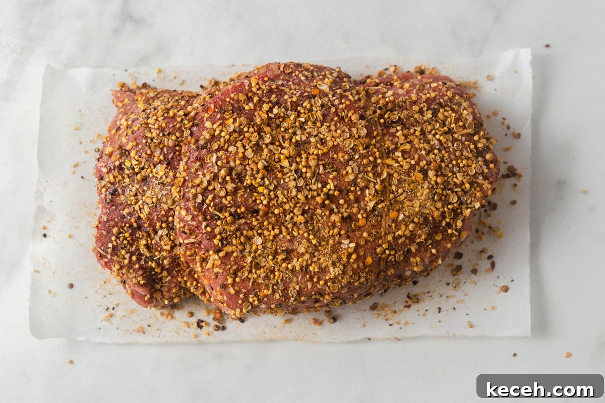 coating the roast beef with spices.