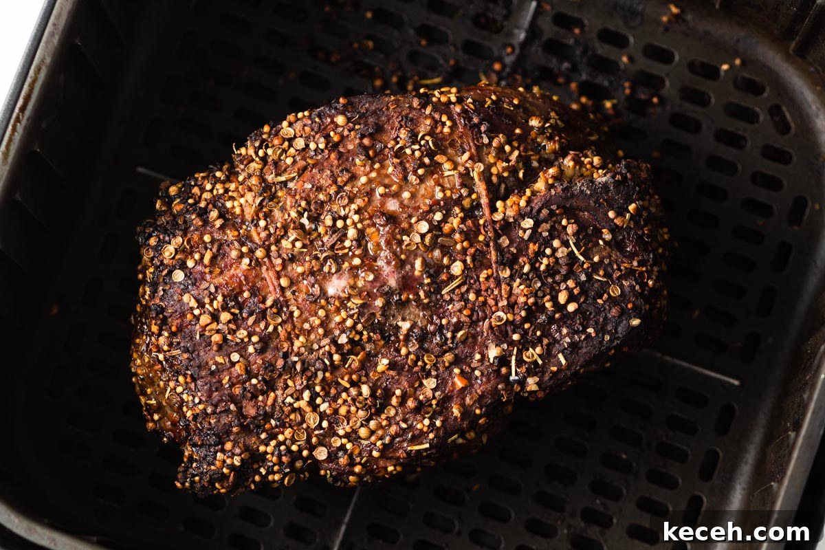 air fried roast beef in the air fryer basket.