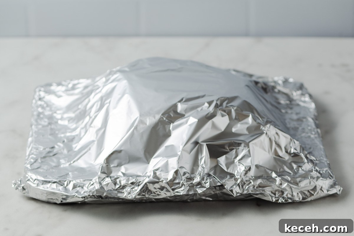 roast beef in a foil tent.