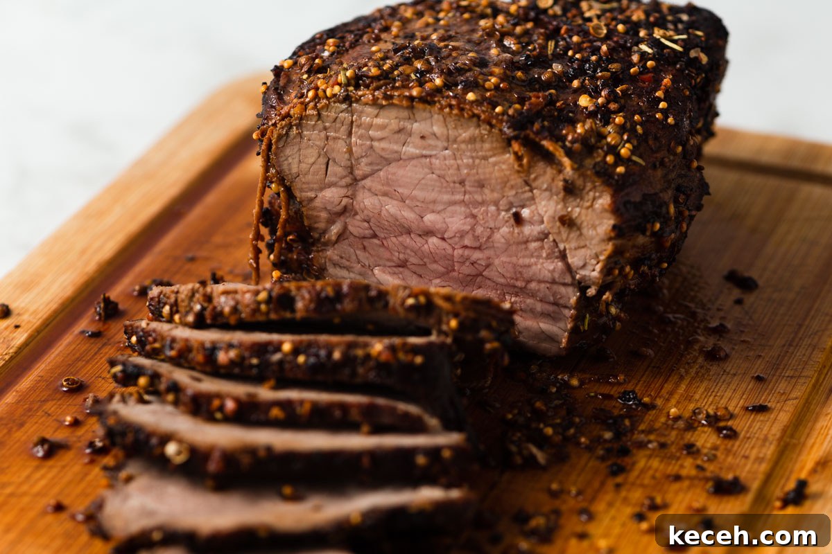 sliced air fryer roast beef on a board.