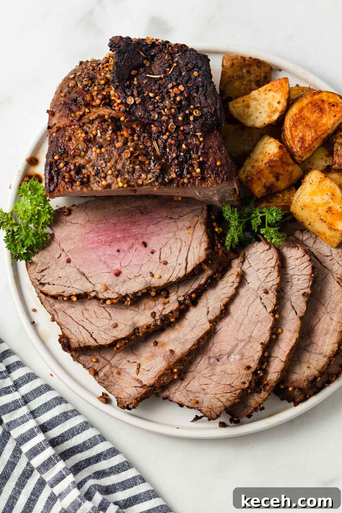 air fryer roast beef sliced on a plate.