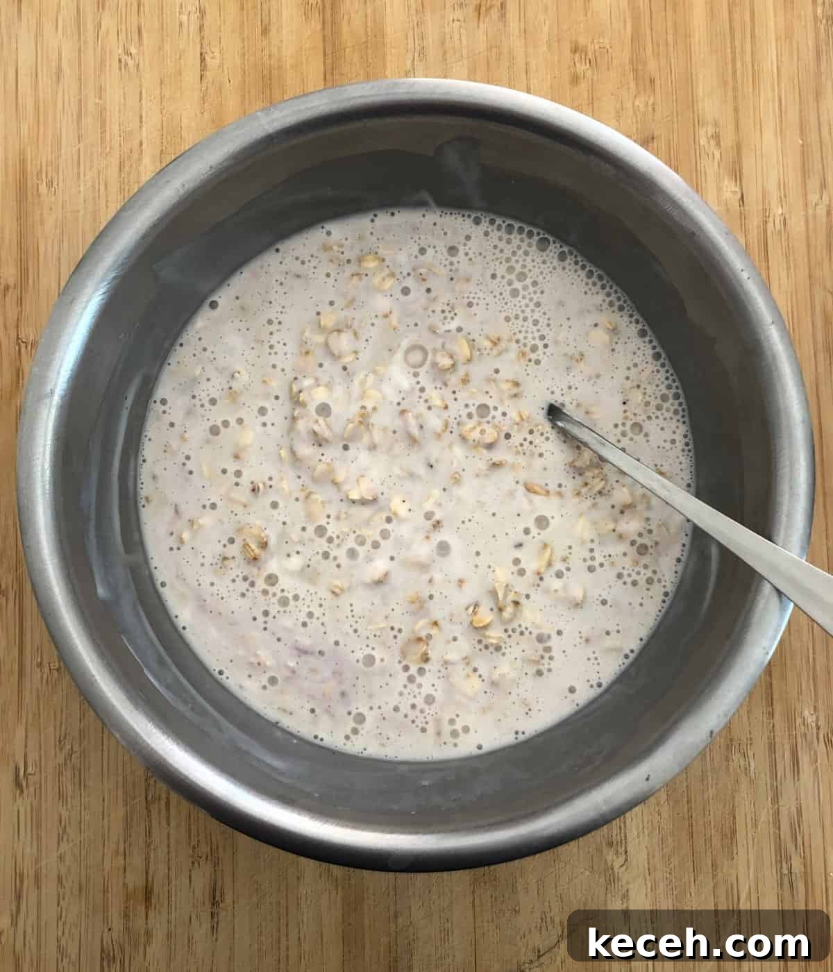 Blueberry and Maple Overnight Oats Recipe for Quick Breakfast 4 Stirring together milk, yogurt and oats in stainless steel mixing bowl.