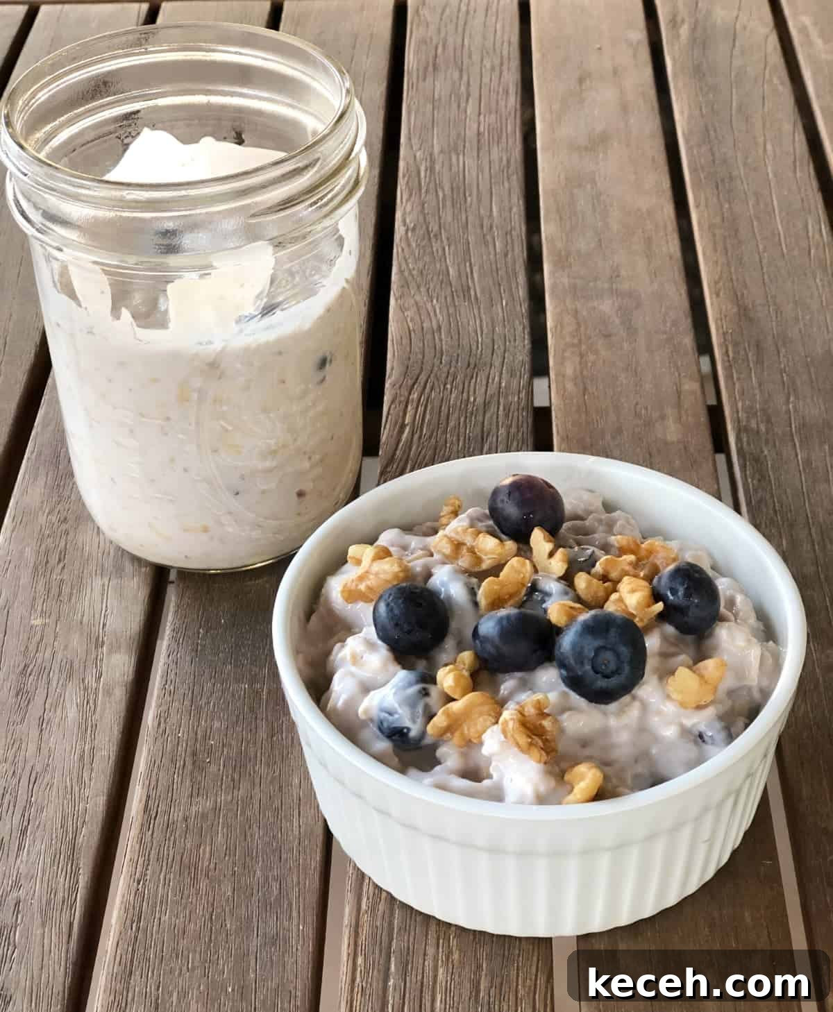 Blueberry and Maple Overnight Oats Recipe for Quick Breakfast 7 Two serving blueberry maple overnight oats, one in glass mason jar, the other topped with walnuts and fresh blueberries in small white ramekin.