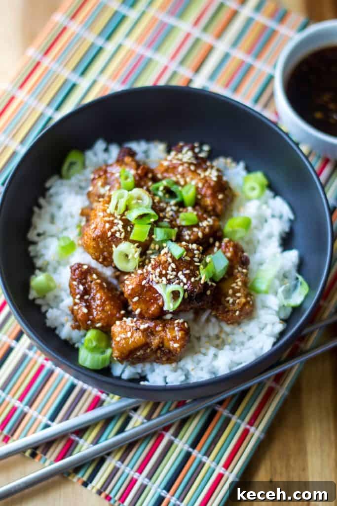 Sticky Chicken Rice Bowl is the perfect combination of tender rice and baked chicken bites covered in a thick sticky sauce and it is sure to be your new favorite sweet and spicy chicken recipe. A quick and easy Asian chicken recipe, this Sticky Chicken Rice Bowl is ready to serve up in just 30 minutes!
