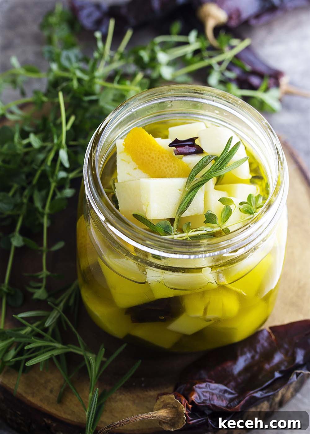 Marinated Manchego Tapas: Savory Spanish Cheese Appetizers 5 Cubes of Spanish manchego cheese marinating in olive oil with herbs and peppers.